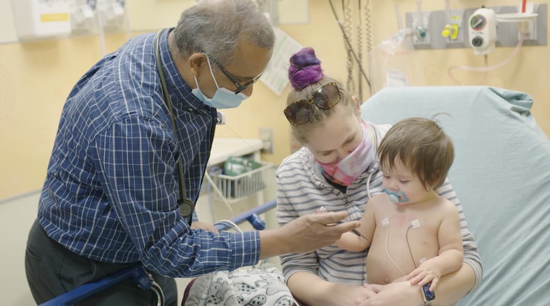 Dr. Pradeep Padmanabhan evaluates a patient at Dayton Children's Hospital. COURTESY OF DAYTON CHILDREN'S HOSPITAL