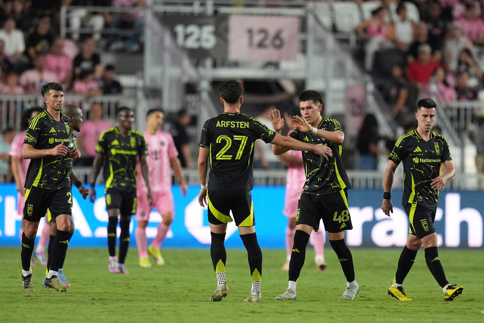 Columbus Crew defender Cesar Ruvalcaba (48) celebrates scoring his side's first goal against Inter Miami, with teammate forward Max Arfsten (27) during the second half of an MLS soccer match, Saturday, May 31, 2025, in Fort Lauderdale, Fla. (AP Photo/Rebecca Blackwell)