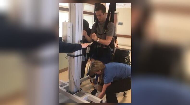 Alexander (Alex) Cash at Atrium Medical Center rehab, using a Lifegait machine with and his inpatient physical therapist, Melissa Kahlig Wolf in January 2018. CONTRIBUTED