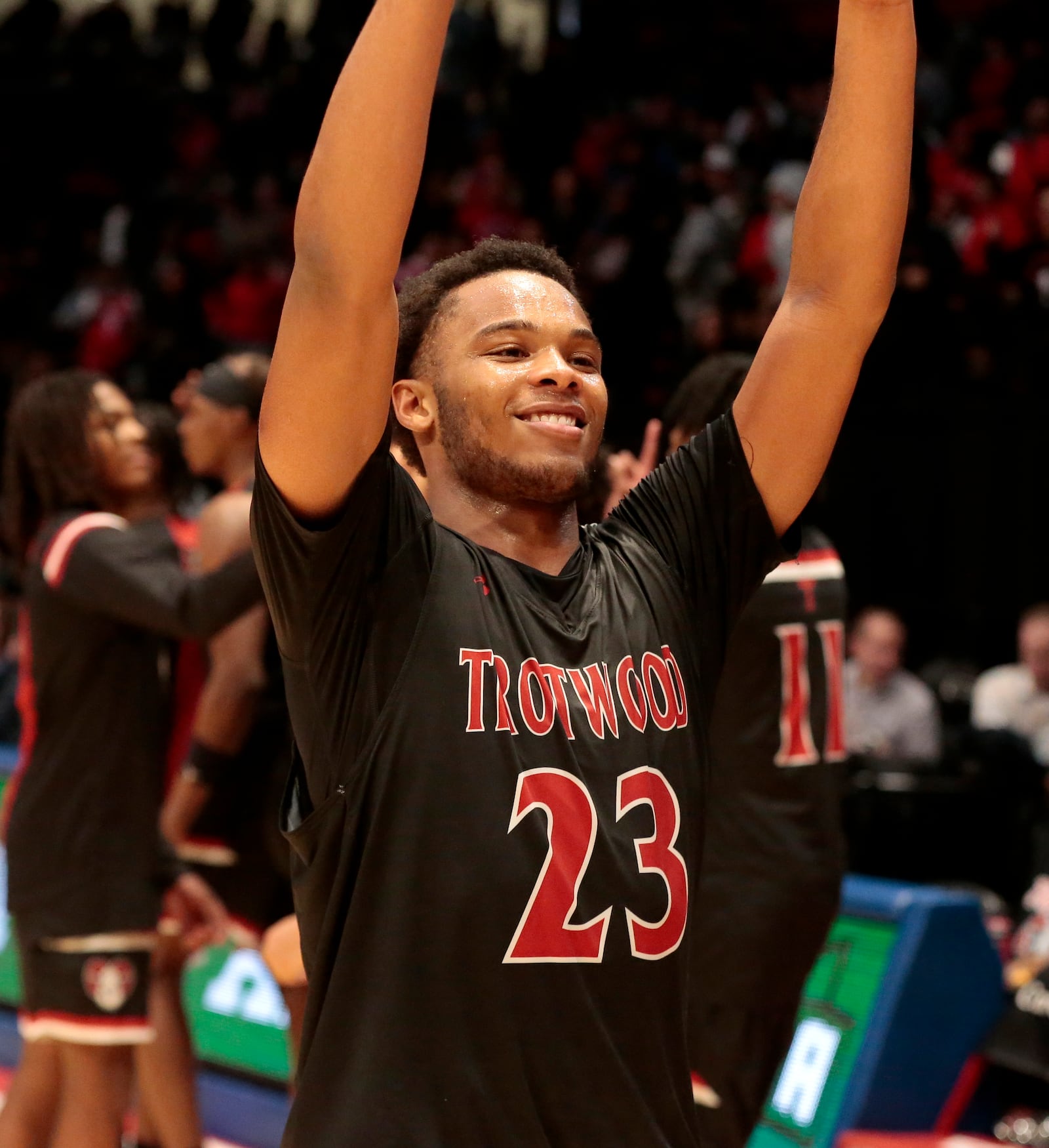 Trotwood junior Darius Dennis smiles as he walks over to his student section in celebration after the Division III state semifinals on Thursday, March 19, 2026, at UD Arena. Trotwood won 55-53. STEVEN WRIGHT / STAFF