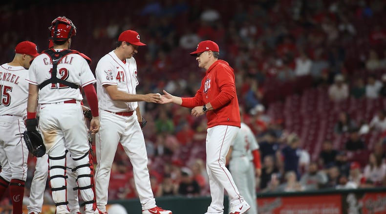 Reds manager David Bell takes the ball from Derek Law in the ninth inning against the Phillies on Thursday, April 13, 2023, at Great American Ball Park in Cincinnati. David Jablonski/Staff