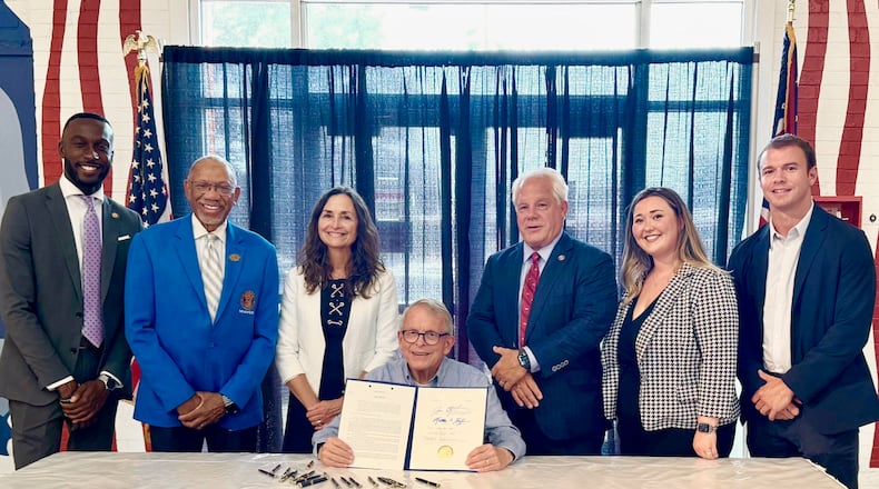 Ohio Gov. Mike DeWine signs an anti-hooning bill that was backed by Dayton Mayor Jeffrey Mims, Jr., along with Dayton-area state legislators Reps. Phil Plummer, R-Butler Twp., and Andrea White, R-Kettering. JULY 24, 2024.