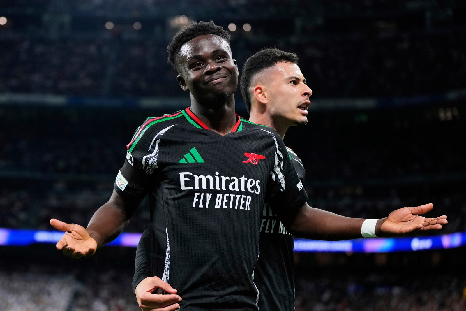 Arsenal's Bukayo Saka celebrates after scoring the opening goal during the Champions League quarterfinals second leg soccer match between Real Madrid and Arsenal at the Santiago Bernabeu stadium in Madrid, Wednesday, April 16, 2025. (AP Photo/Manu Fernandez)