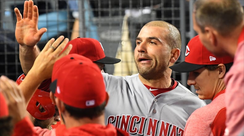 LOS ANGELES, CA - MAY 10:  Joey Votto #19 of the Cincinnati Reds is greeted in the dugout after scoring a run in the fourth inning of the game against the Los Angeles Dodgers at Dodger Stadium on May 10, 2018 in Los Angeles, California.  (Photo by Jayne Kamin-Oncea/Getty Images)