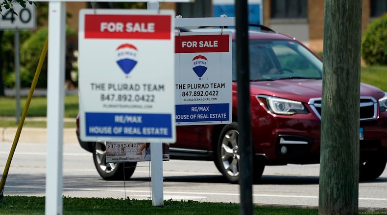 "For Sale" signs are seen outside a home in Glenview, Ill., Tuesday, July 27, 2021.  Mortgage rates were flat to lower last week, Aug. 5, with the average for the key 30-year home loan below 3% for the sixth straight week.    (AP Photo/Nam Y. Huh)