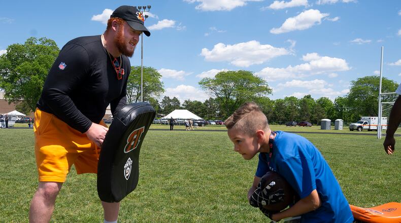 Cincinnati Bengal guard Desmond Noel works with a participant in the USO-sponsored Bengals’ skill clinic June 3 at Wright-Patterson Air Force Base. A group of Bengal rookies had lunch with Airmen, toured the base and took part in the skill clinic that had 99 Wright-Patt children enrolled. U.S. Air Force photo / R.J. Oriez