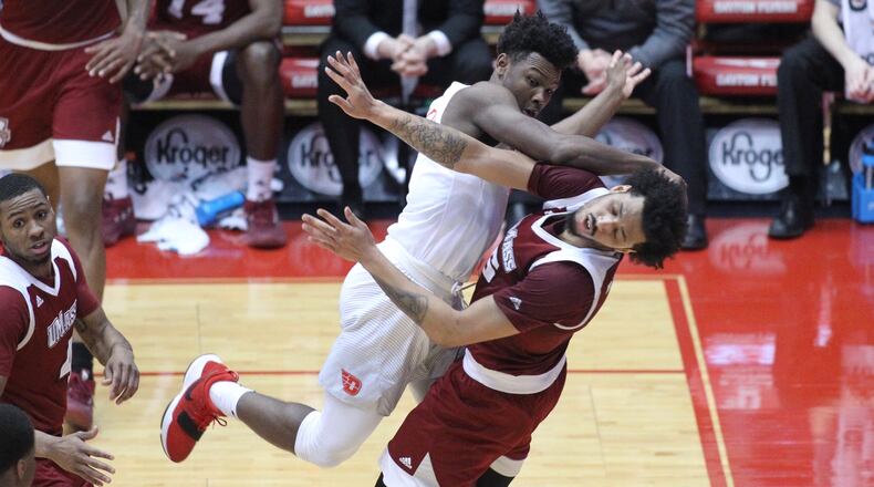 Dayton's Jordan Davis runs into Massachusetts' Chris Baldwin on Saturday, Jan. 6, 2018, at UD Arena.