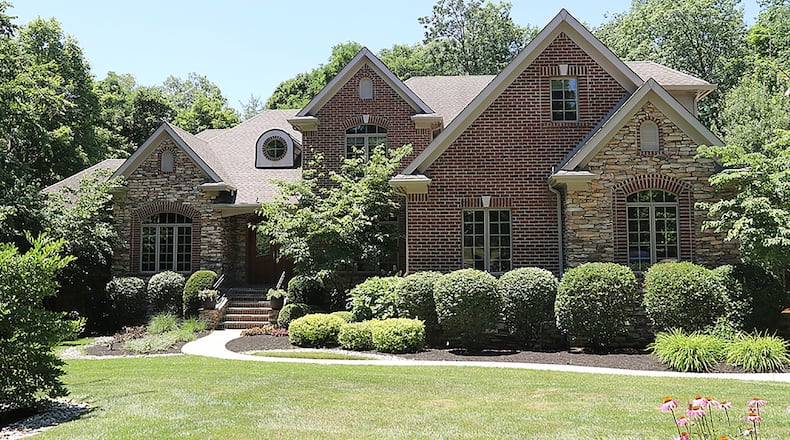The brick-and-stone, 2-story has about 8,180 sq. ft. of living space. Each of the three levels offers a flexible floor plan that allows formal, casual or quiet-time living. The home offers 5 bedrooms, a 3-season room and side-entry, 3-car garage. CONTRIBUTED PHOTO BY KATHY TYLER