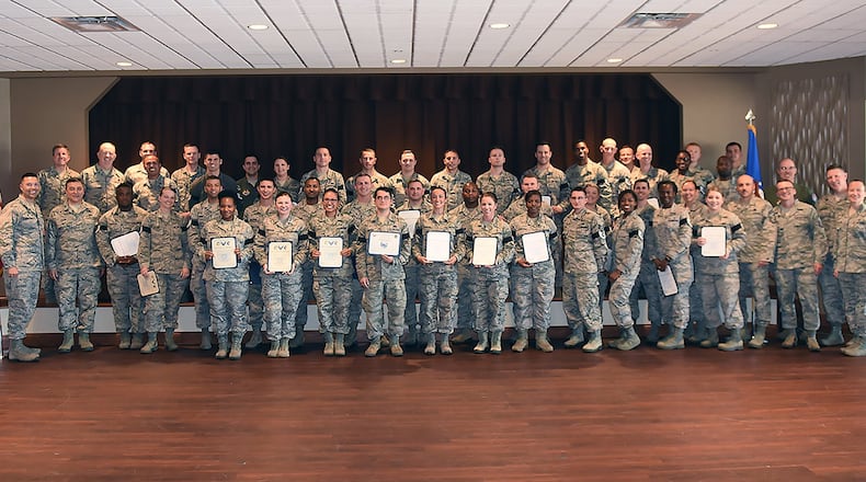 Col. Thomas Sherman, (left), 88th Air Base Wing and installation commander, and Chief Master Sgt. Stephen Arbona (third from right), 88 ABW command chief, congratulate the newest Team Wright-Patt technical sergeant selects during a ceremony at the Wright-Patterson Club July 19. (U.S. Air Force photo/Al Bright)