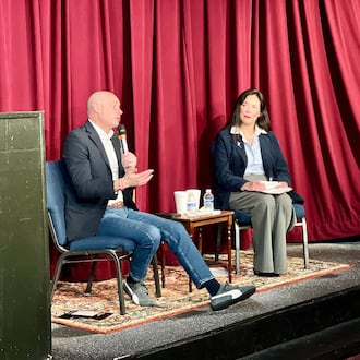 U.S. Rep Greg Landsman answers questions during a town hall event in Lebanon on Sunday, March 22, 2026, alongside a moderator. AIMEE HANCOCK/STAFF