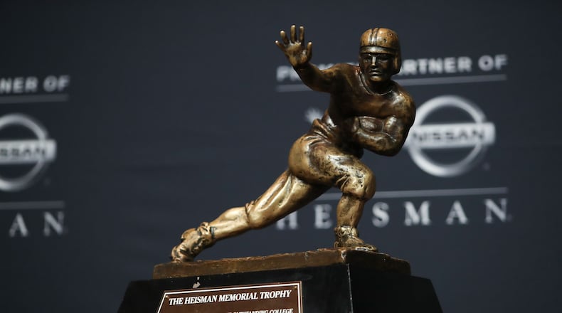 NEW YORK, NY - DECEMBER 10: (L-R) A general view of the Heisman Trophy during a press conference prior to the 2016 Heisman Trophy Presentation on December 10, 2016 in New York City. (Photo by Michael Reaves/Getty Images)