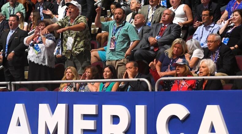 Attendees shout as Sen. Ted Cruz, R-Tex., delivers his speech during the third day of the Republican National Convention in Cleveland, Wednesday, July 20, 2016. (AP Photo/Mark J. Terrill)