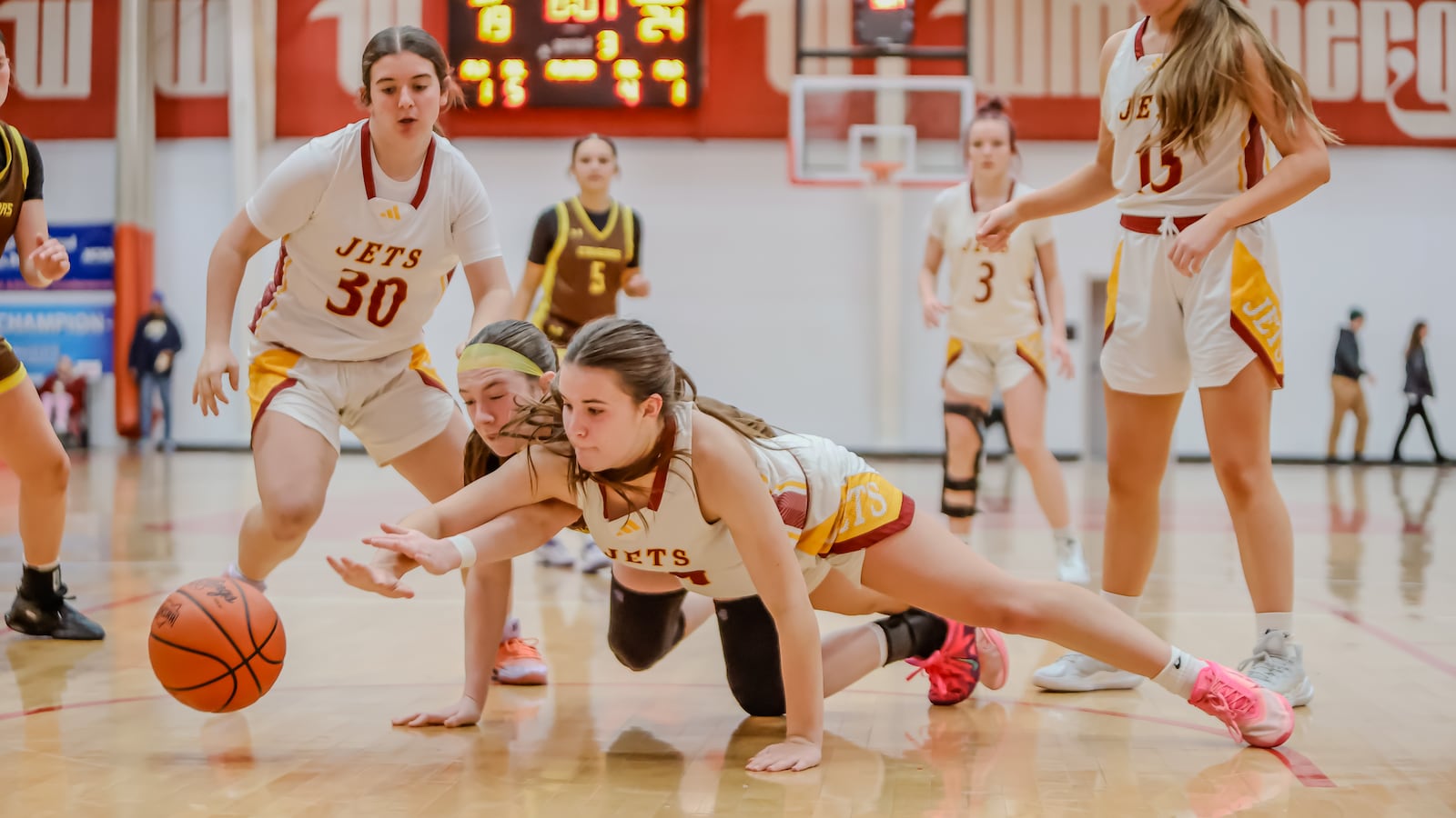 Northeastern's Taylor Krauss and Kenton Ridge's Addison Jenkins dive for a loose ball during their game at the Clark County Basketball Showcase on Tuesday, Dec. 30 at Pam Evans Smith Arena in Springfield. MICHAEL COOPER / CONTRIBUTED PHOTO