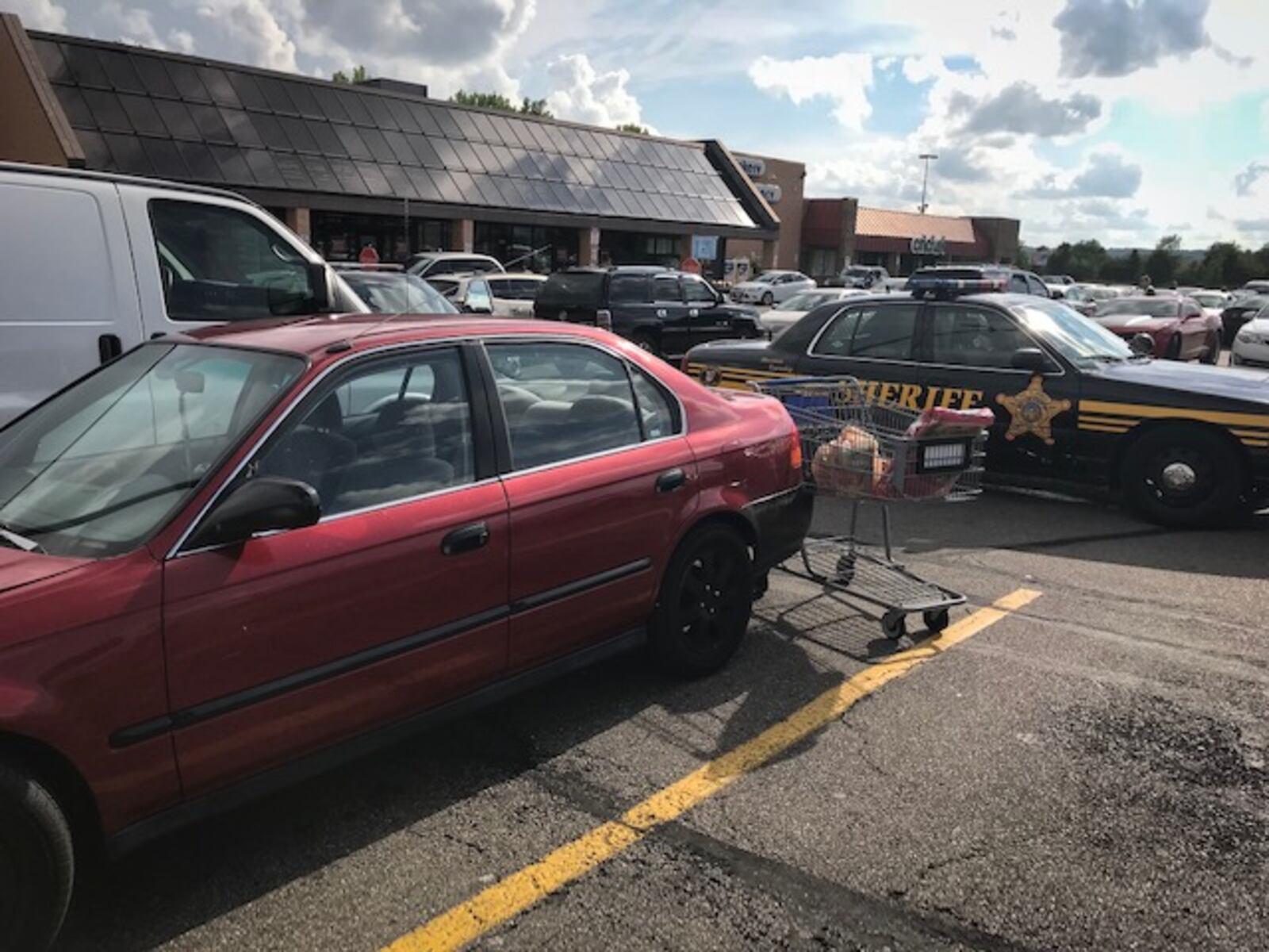 A baby, believed to be 18 months old, was found in this car in a Kroger parking lot on Wednesday afternoon in Harrison Twp. Sheriff's deputies booked the dad into jail on a charge of child endangerment. (Jim Noelker/Staff)