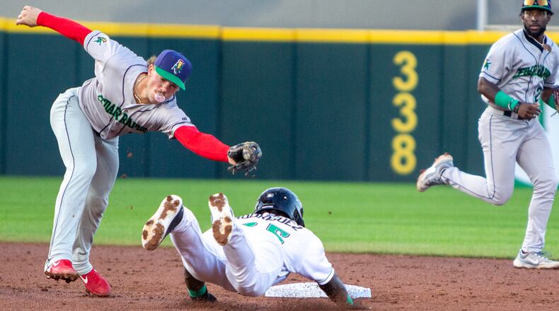 Dayton's Hector Rodriguez is caught stealing on the tag be Cedar Rapids second baseman Nick Lucky while he blows a bubble in the third inning of Saturday night's game at Day Air Ballpark. Jeff Gilbert/CONTRIBUTED