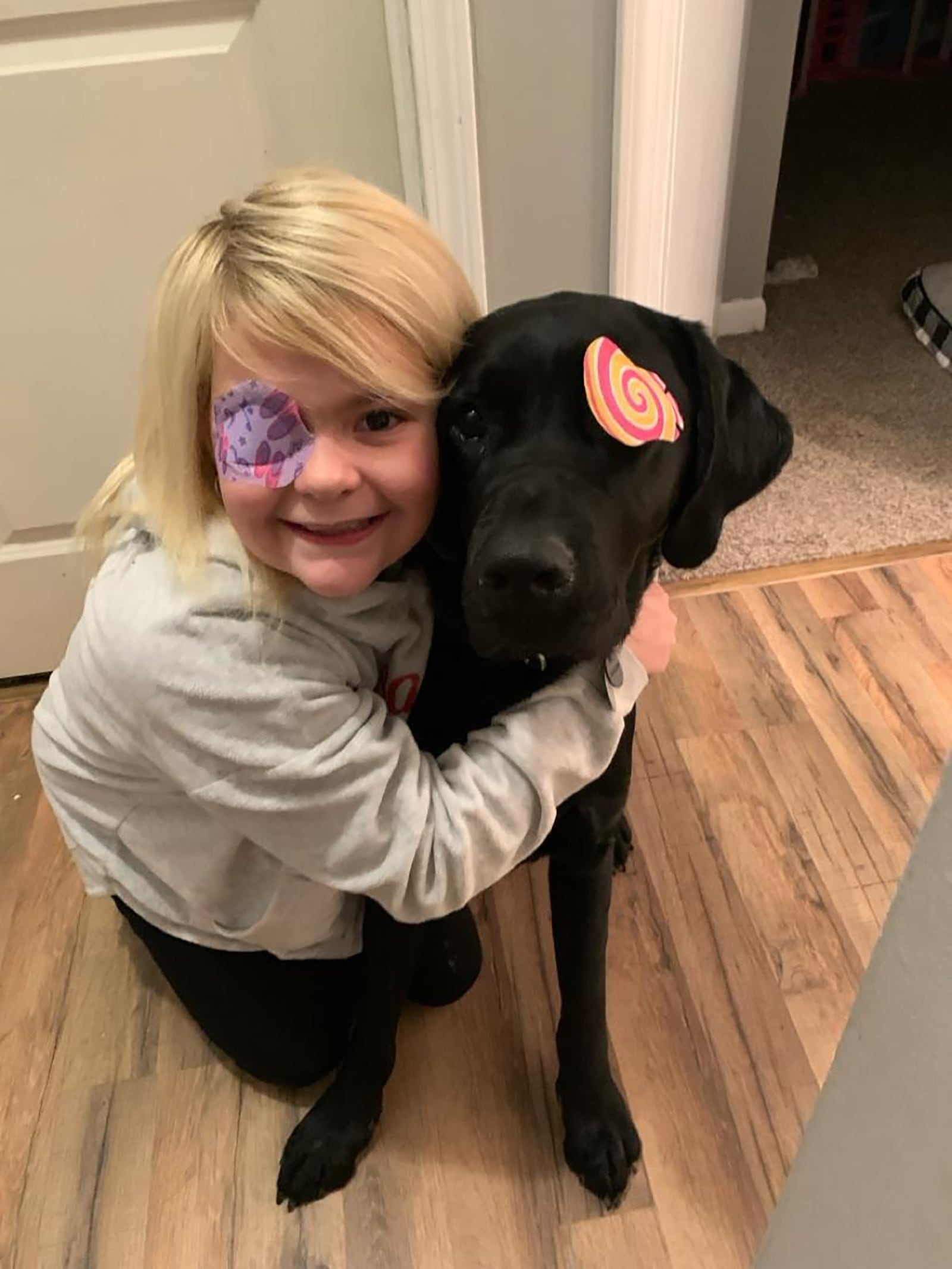 Emma Brown with her skilled companion dog, Sloane. Sloane came to the Brown family in March of 2005 and he and Emma, who is blind in her right eye, became instant best friends. Here Sloane wears an eye patch just like Emma. CONTRIBUTED