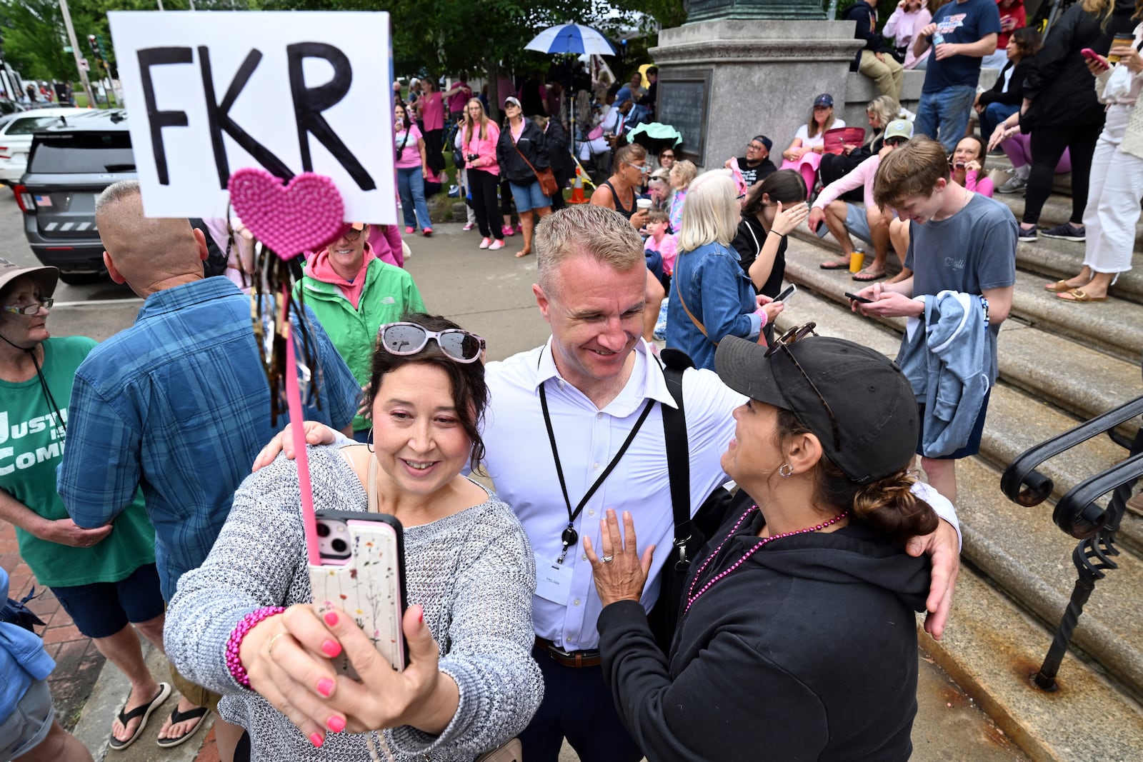 Blogger Aidan Kearney, center, meets with fans and Karen Read supporters, from left, Linda Allen of Rockland, MA, and Shannon LoPorto of Weymouth, MA, outside the Dedham, Mass. courthouse on the third day of jury deliberations in Read's trial at Norfolk Superior Court, Wednesday, June 18, 2025, in Dedham, Mass. (AP Photo/Josh Reynolds)