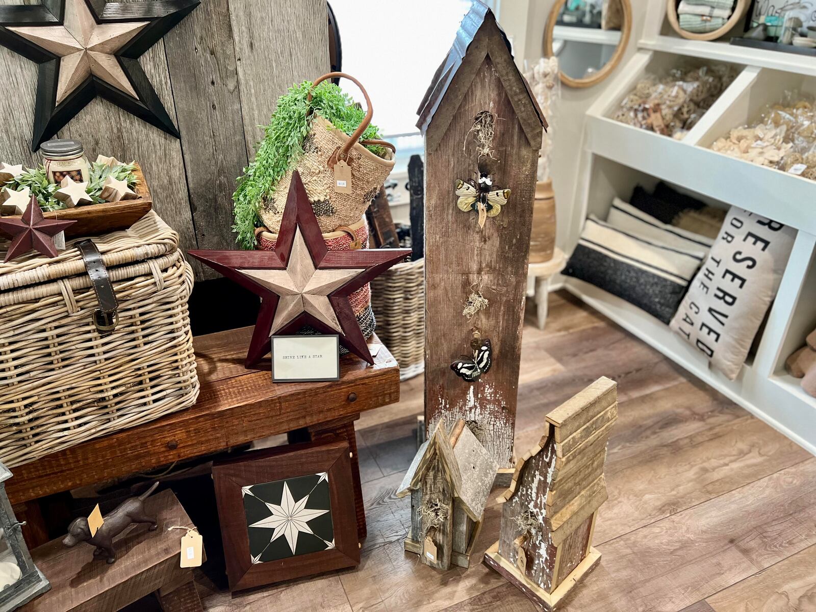Rustic & Rooted in Englewood offers an array of merchandise, from home decor and personal care products, to ground coffee and multiple types of barbeque sauces and cocktail mixers. The wooden decorations seen here are hand-crafted by co-owner Jeff Stoltz. AIMEE HANCOCK/STAFF