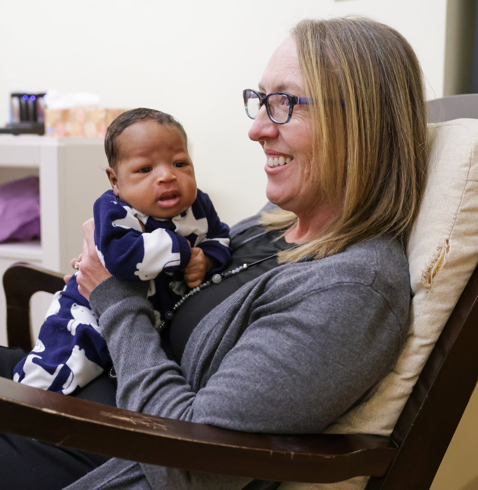 Brigid's Path founder and president Jill Kingston smiles while holding an infant at the newborn recovery center on Wednesday, Feb. 18 in Kettering. "It's taken an act of Congress for us to even get this far," Kingston said of the center's more than decade long pursuit to receive Medicaid reimbursement for infants it treats for neonatal abstinence syndrome. BRYANT BILLING / STAFF