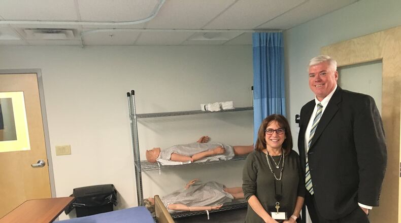 Jerry Farley, director of Dayton YouthBuild, and Linda Kramer, CEO of Daybreak, stand in a lab that simulates a doctor’s office or nursing home medical exam room to train students. The lab will also be used to treat young people with alcohol or other drug addictions. CORNELIUS FROLIK / STAFF
