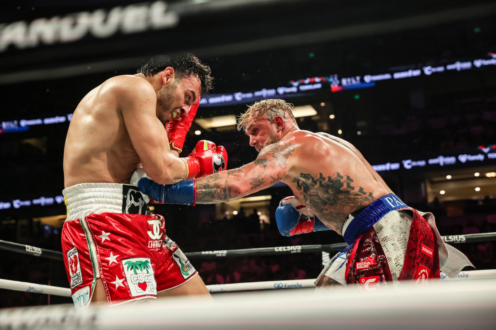 Jake Paul, right, punches Julio Cesar Chavez Jr. during their cruiserweight boxing match on Saturday, June 28, 2025, in Anaheim, Calif. (AP Photo/Etienne Laurent)