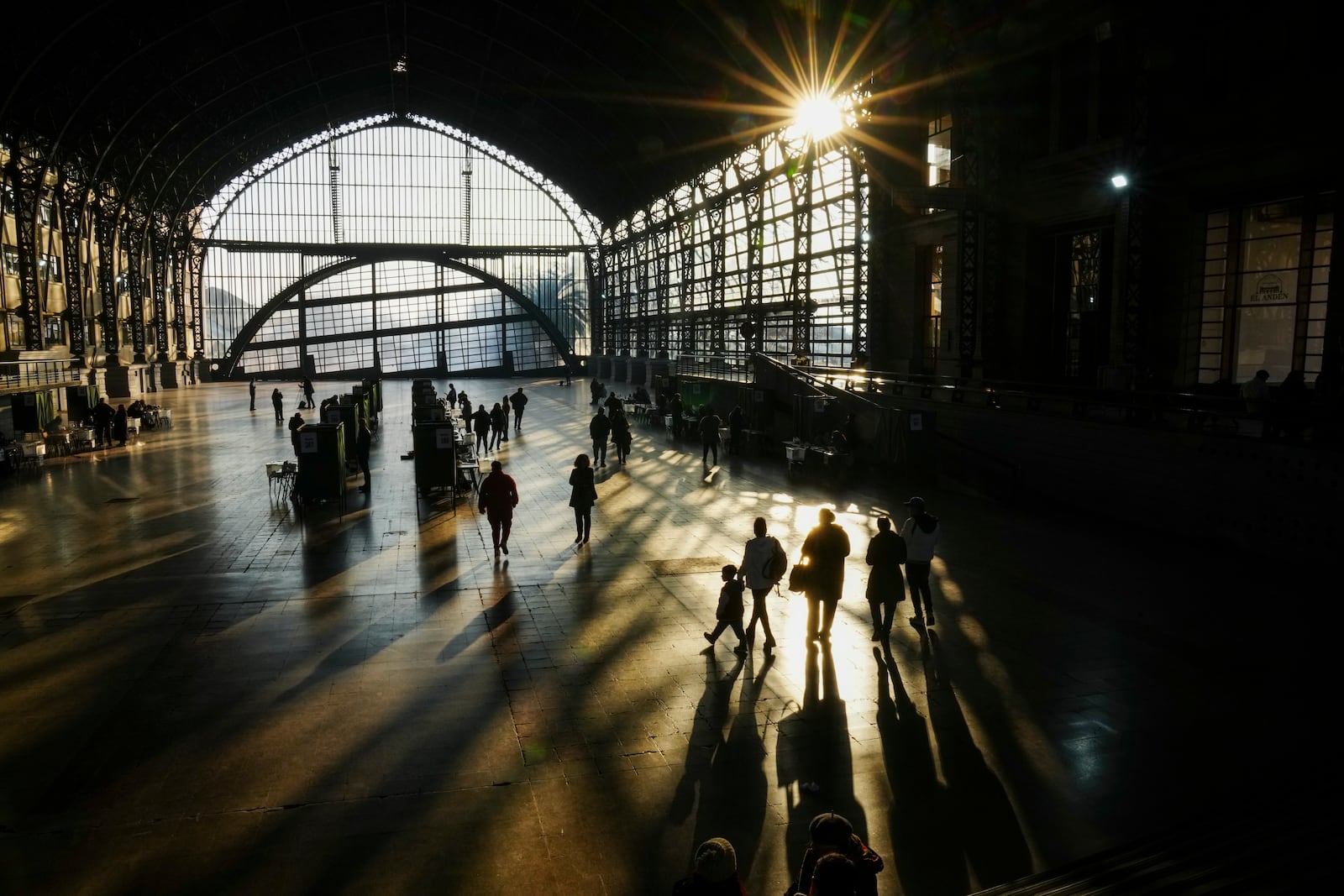 People head to cast their ballots in the former Mapocho railway station during a primary held by the Unidos por Chile coalition to choose the ruling party's candidate for the upcoming presidential election, in Santiago, Chile, Sunday, June 29, 2025. (AP Photo/Esteban Felix)