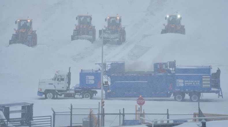 Airport crew plow snow during a winter storm in Philadelphia, Sunday, Jan. 25, 2026. (AP Photo/Matt Rourke)