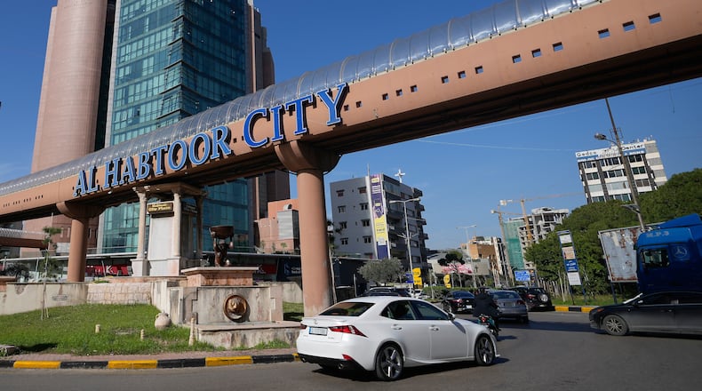 Cars pass next to Habtoor hotel, left, in Beirut, Lebanon, Monday, Jan. 26, 2026. (AP Photo/Hassan Ammar)