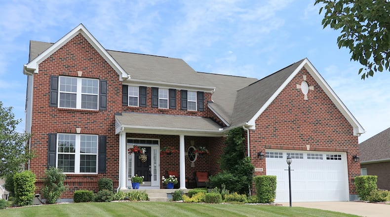 The brick-and-vinyl home has about 4,030 sq. ft. of living space, including the lower level. The home offers 4 bedrooms and a 2-car garage. CONTRIBUTED PHOTO BY KATHY TYLER