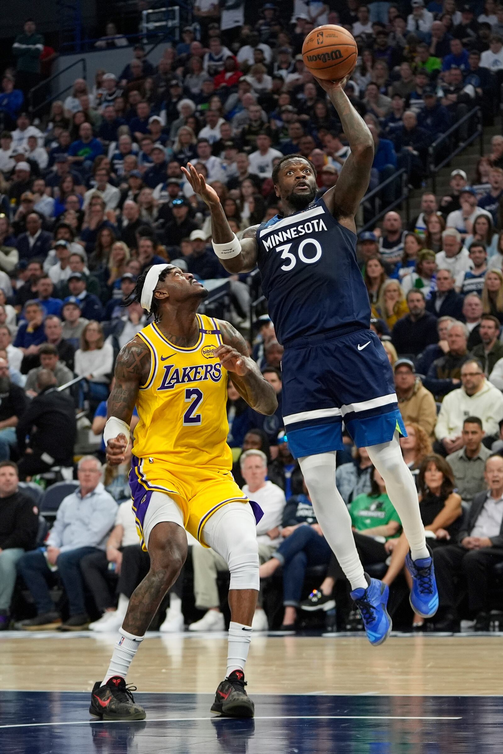 Minnesota Timberwolves forward Julius Randle (30) goes up for a shot as Los Angeles Lakers forward Jarred Vanderbilt (2) defends during the first half of Game 3 of an NBA basketball first-round playoff series, Friday, April 25, 2025, in Minneapolis. (AP Photo/Abbie Parr)