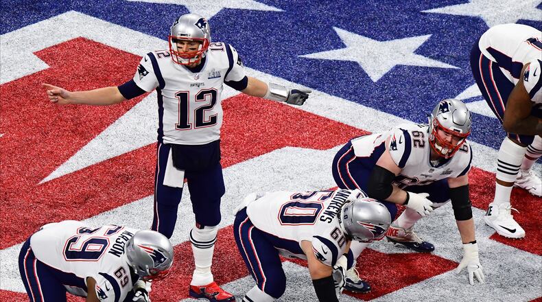 ATLANTA, GEORGIA - FEBRUARY 03: Tom Brady #12 of the New England Patriots prepares to run the play against the Los Angeles Rams during the first quarter during Super Bowl LIII at Mercedes-Benz Stadium on February 03, 2019 in Atlanta, Georgia. (Photo by Scott Cunningham/Getty Images)