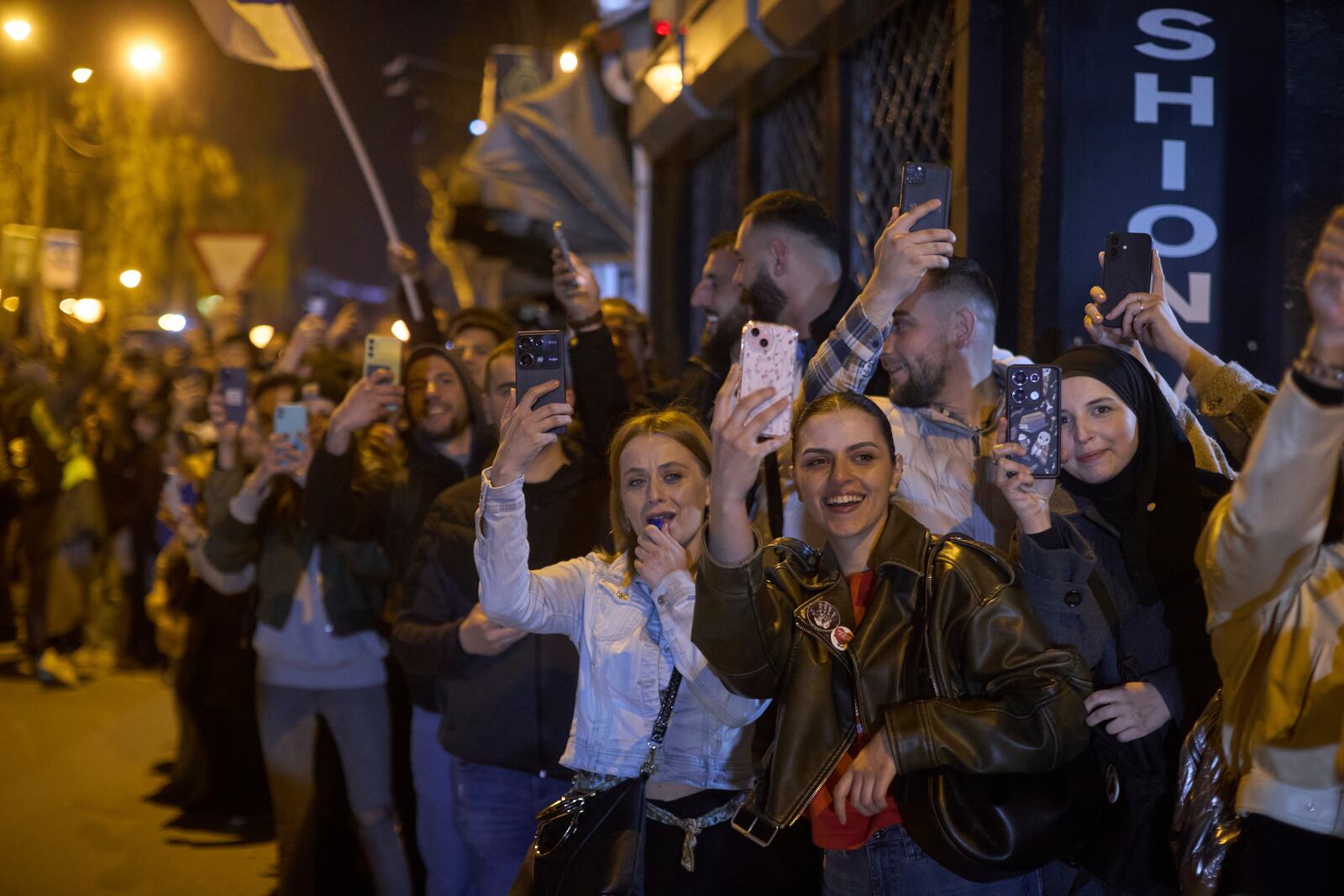 Locals greet a group of students who walked across the country as they arrive at an anti-corruption protest in the southwestern town of Novi Pazar, Serbia, Friday, April 11, 2025. (AP Photo/Marko Drobnjakovic)