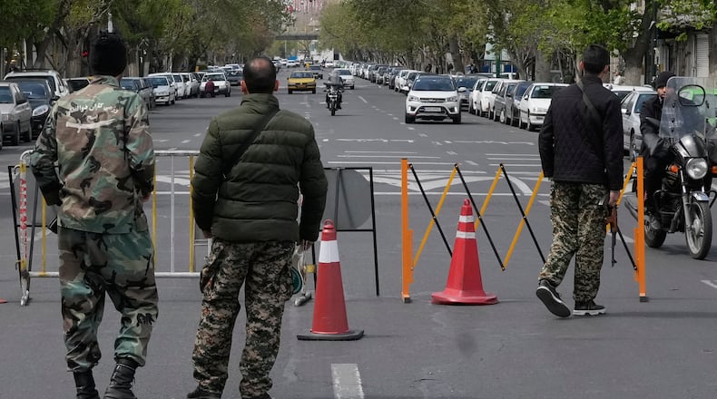 Members of the Basij paramilitary force stand at a checkpoint in Tehran, Iran, Sunday, March 29, 2026. (AP Photo/Vahid Salemi)