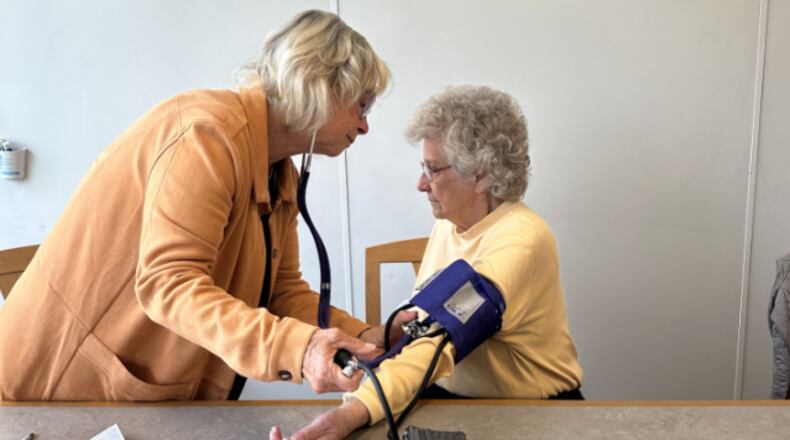 Julie Falsick Johnson and Sally Carles participate in the blood pressure clinic offered through Kettering's Senior Services Program. CONTRIBUTED