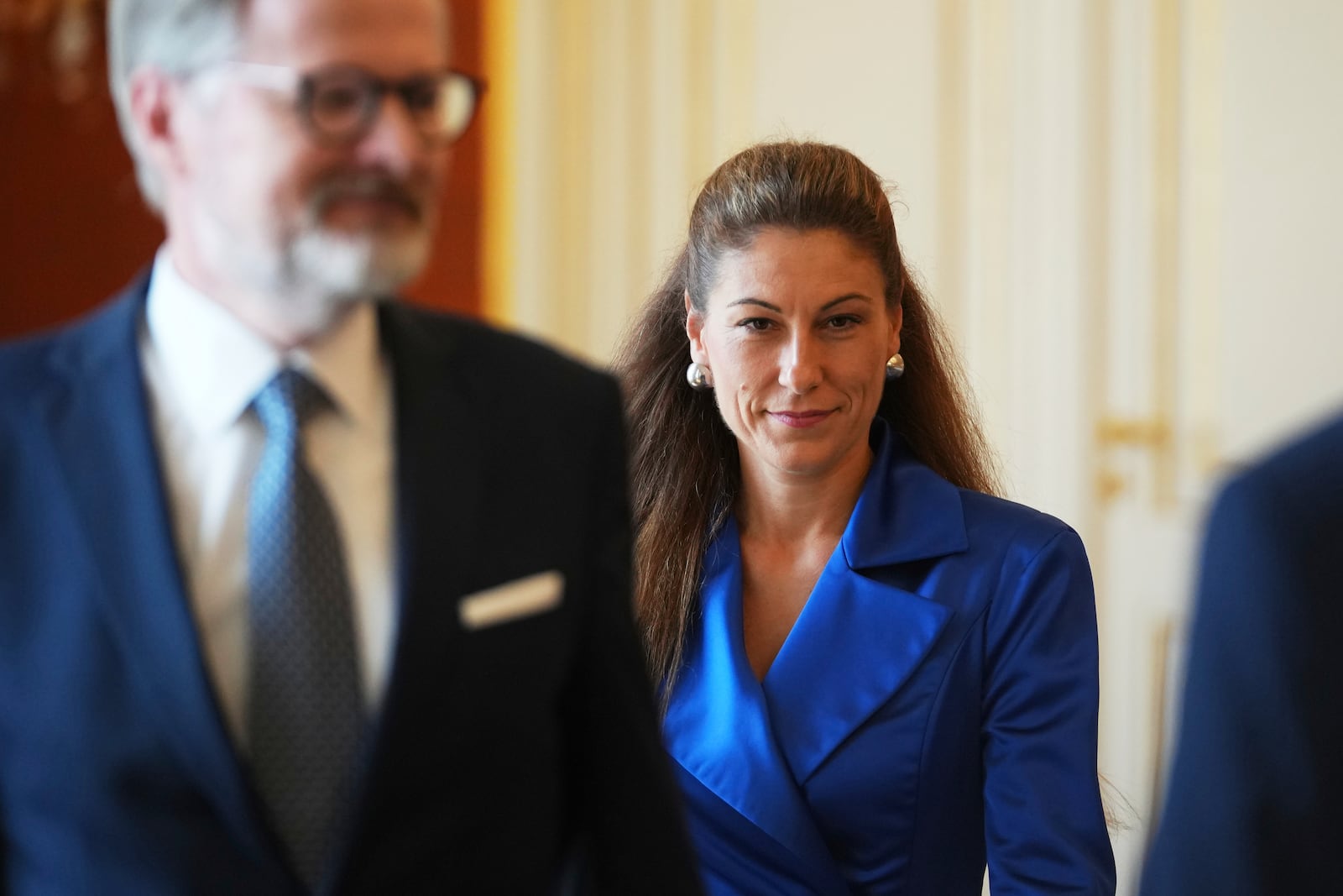 Czech Republic's Prime Minister Petr Fiala, left, looks on as Eva Decroix arrives to be appointed as new Justice Minister at the Prague Castle in Prague, Czech Republic, Tuesday, June 10, 2025. (AP Photo/Petr David Josek)