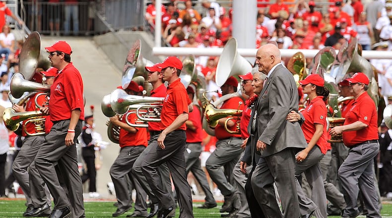 COLUMBUS, OH - SEPTEMBER 05: Former U.S. Senator John Glenn (D-OH) and his wife Annie Glenn walk off the field after dotting the ‘i’ as the Ohio State Alumni Marching Band forms script Ohio during halftime of a game against the Navy Midshipmen at Ohio Stadium on September 5, 2009 in Columbus, Ohio. (Photo by Jamie Sabau/Getty Images)
