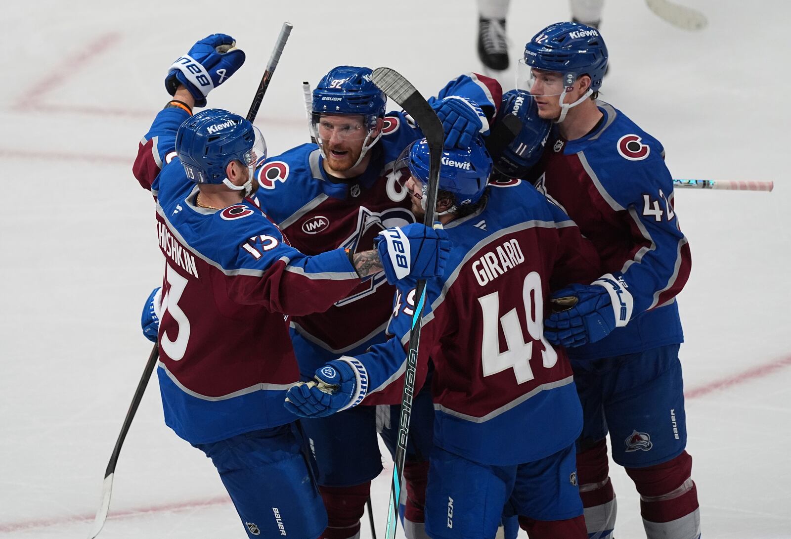 Colorado Avalanche defenseman Samuel Girard (49) is congratulated after scoring a goal by, from left, right wing Valeri Nichushkin, left wing Gabriel Landeskog (92) and defenseman Josh Manson in the third period of Game 4 of an NHL hockey first-round playoff series Saturday, April 26, 2025, in Denver. (AP Photo/David Zalubowski)