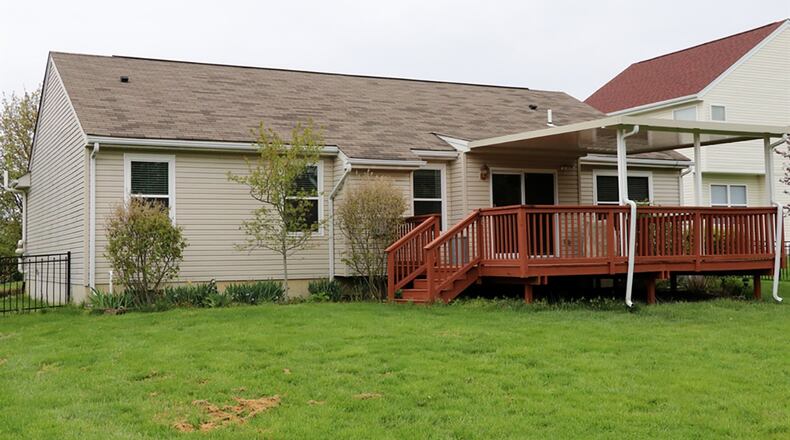 The back yard is fenced and patio doors from the kitchen open to the deck, part of which is covered.