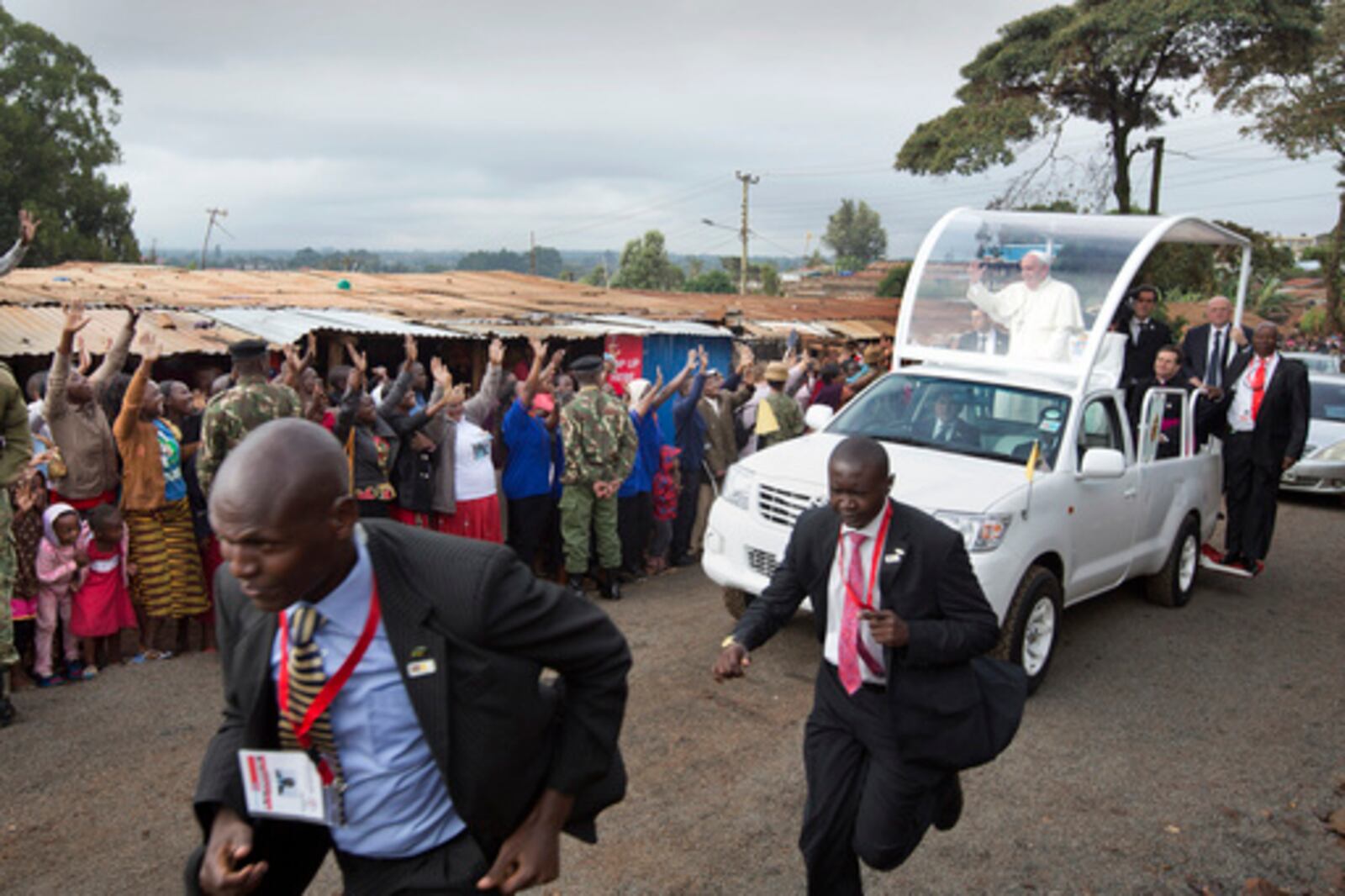 FILE - Pope Francis waves to local residents as he drives to St. Joseph The Worker Catholic Church in the Kangemi slum of Nairobi, Kenya, Friday, Nov. 27, 2015. (AP Photo/Ben Curtis, file)