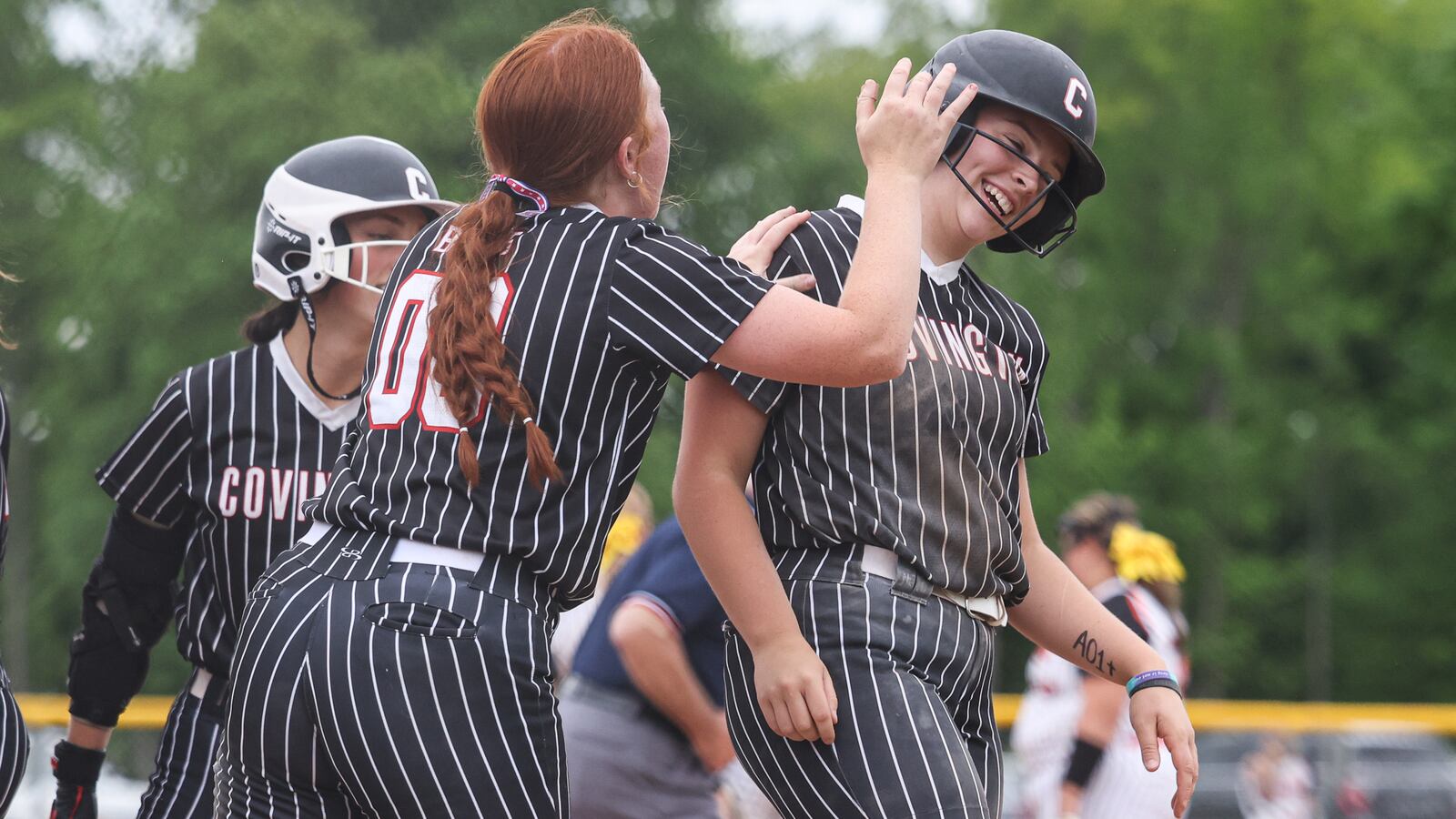 Covington sophomore Cassidy Iddings celebrates with Elizabeth Coblentz after Coblentz hit a home run during a Division VII regional semifinal against Ansonia on Wednesday at Northmont High School. Coblentz was 3 for 3 with 3 RBIs, one home run, one double and one walk in the squad's 14-3 win. BRYANT BILLING / STAFF