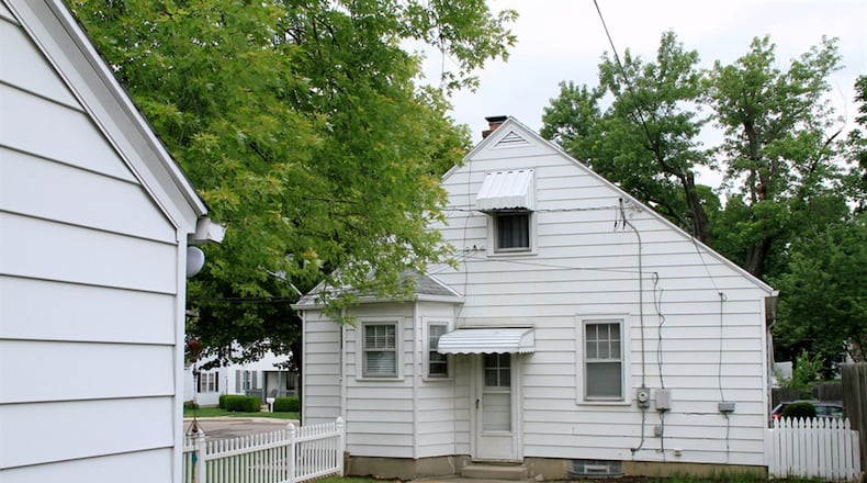 The back yard has a white vinyl picket fence, and the garage has its own private driveway at the back of the property with alley access.