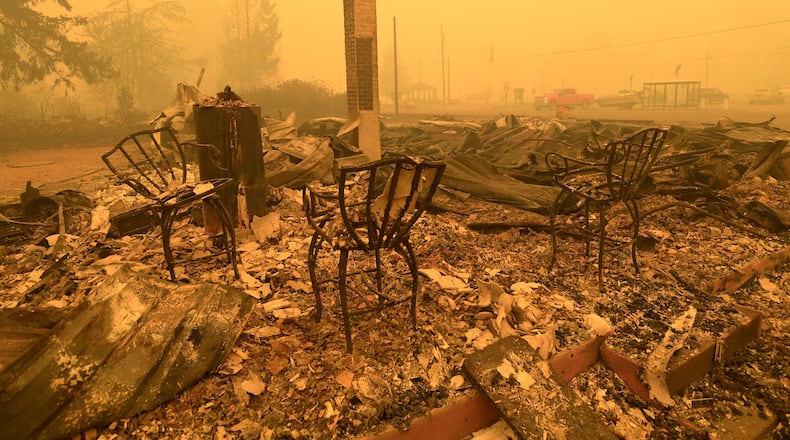 FILE - Chairs stand at a post office in the aftermath of the Santiam Fire, in Gates, Ore., Sept 9, 2020. (Mark Ylen/Albany Democrat-Herald via AP, File)