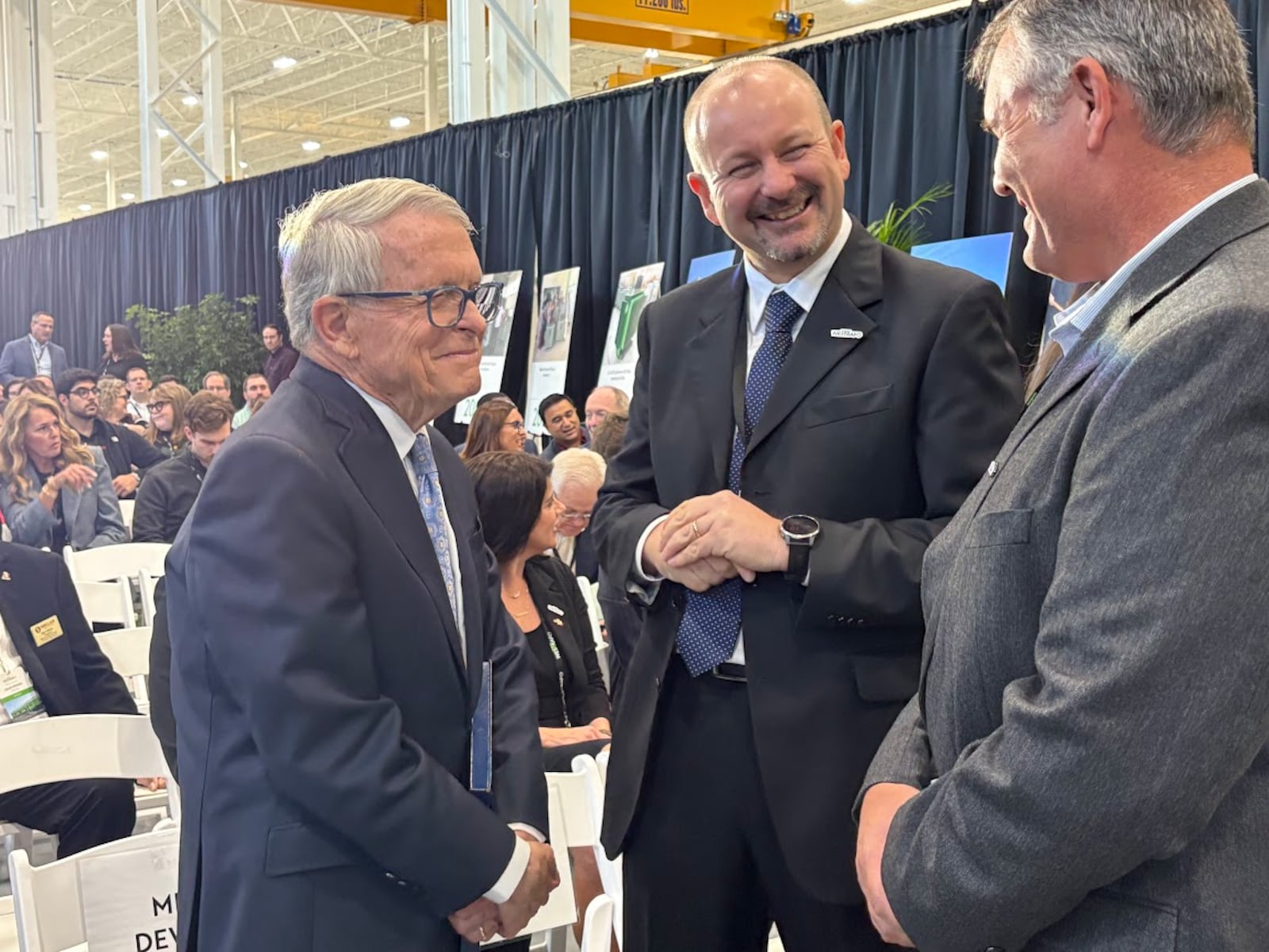 Sharing a laugh at Westrafo's Trotwood plant on Thursday, Oct. 9, 2025: From left, Ohio Gov. Mike DeWine, Alberto Cracco, chairman and chief executive of Westrafo and Matt Bigaouette, customer service manager for Westrafo. THOMAS GNAU/STAFF