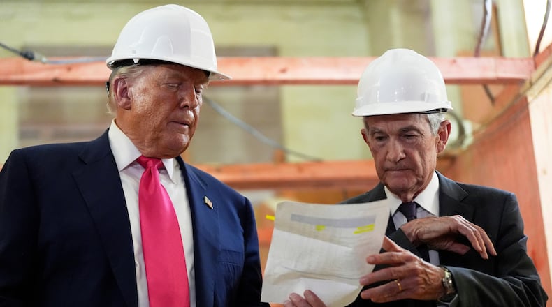 FILE - Federal Reserve Chairman Jerome Powell, right, and President Donald Trump look over a document of cost figures during a visit to the Federal Reserve, Thursday, July 24, 2025, in Washington. (AP Photo/Julia Demaree Nikhinson, File)