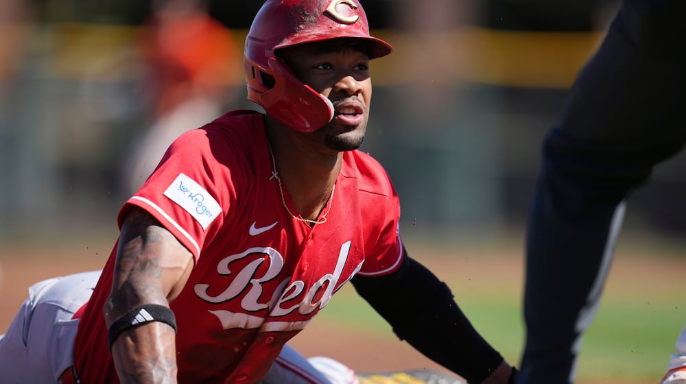 Cincinnati Reds' Will Benson steals third base against the San Francisco Giants during the first inning of a spring training baseball game Friday, March 6, 2026, in Scottsdale, Ariz. (AP Photo/Ross D. Franklin)