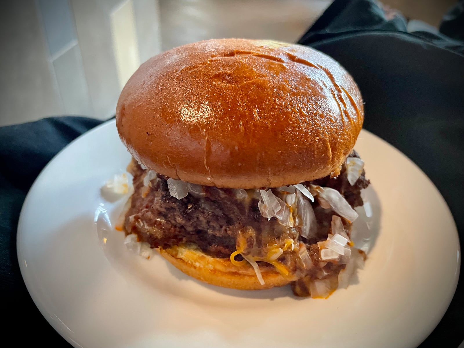 CMX CinéBistro at the Liberty Center has launched a new menu offering elevated theater food and snacks. Pictured is the Cincinnati chili cheeseburger. NATALIE JONES/STAFF