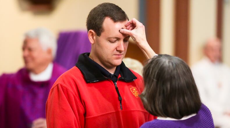 FILE Andy Guiler. of Middletown, receives ashes during the Ash Wednesday service at Holy Trinity Catholic Church in Middletown. GREG LYNCH / STAFF