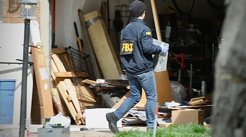 Several local law-enforcement agencies and the FBI go through a home on Barnhart Road in Troy Friday morning, April 5, 2024. MARSHALL GORBY \STAFF