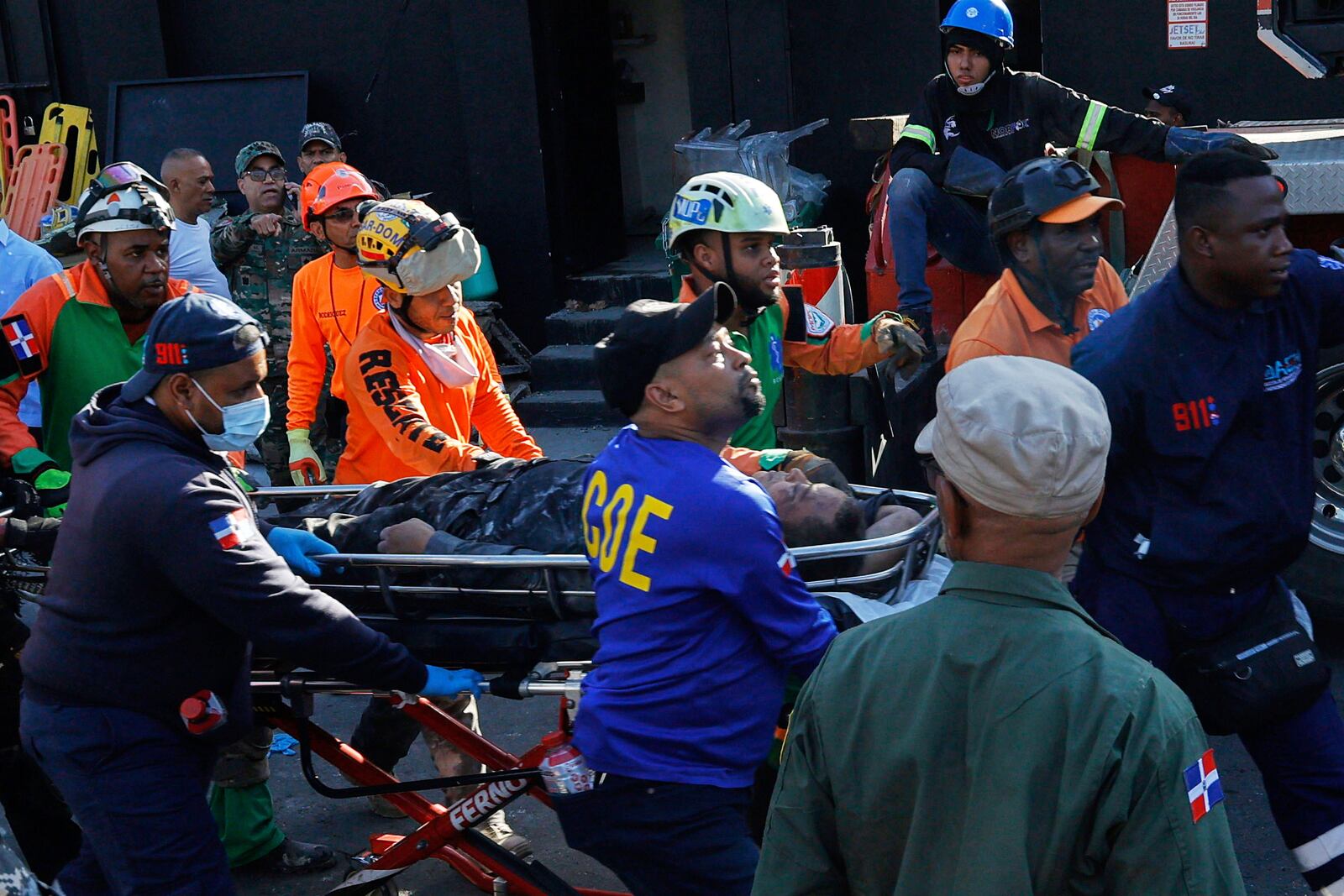 Rescue workers carry a person pulled from the wreckage of the nightclub after its roof collapsed during a merengue concert in Santo Domingo, Dominican Republic, Tuesday, April 8, 2025. (AP Photo/Eddy Vittini)