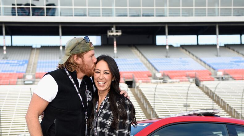 FORT WORTH, TX - NOVEMBER 05:  'Fixer Upper' stars Chip and Joanna Gaines pose with the Monster Energy NASCAR Cup Series AAA Texas 500 pace car at Texas Motor Speedway on November 5, 2017 in Fort Worth, Texas.  (Photo by Jared C. Tilton/Getty Images)